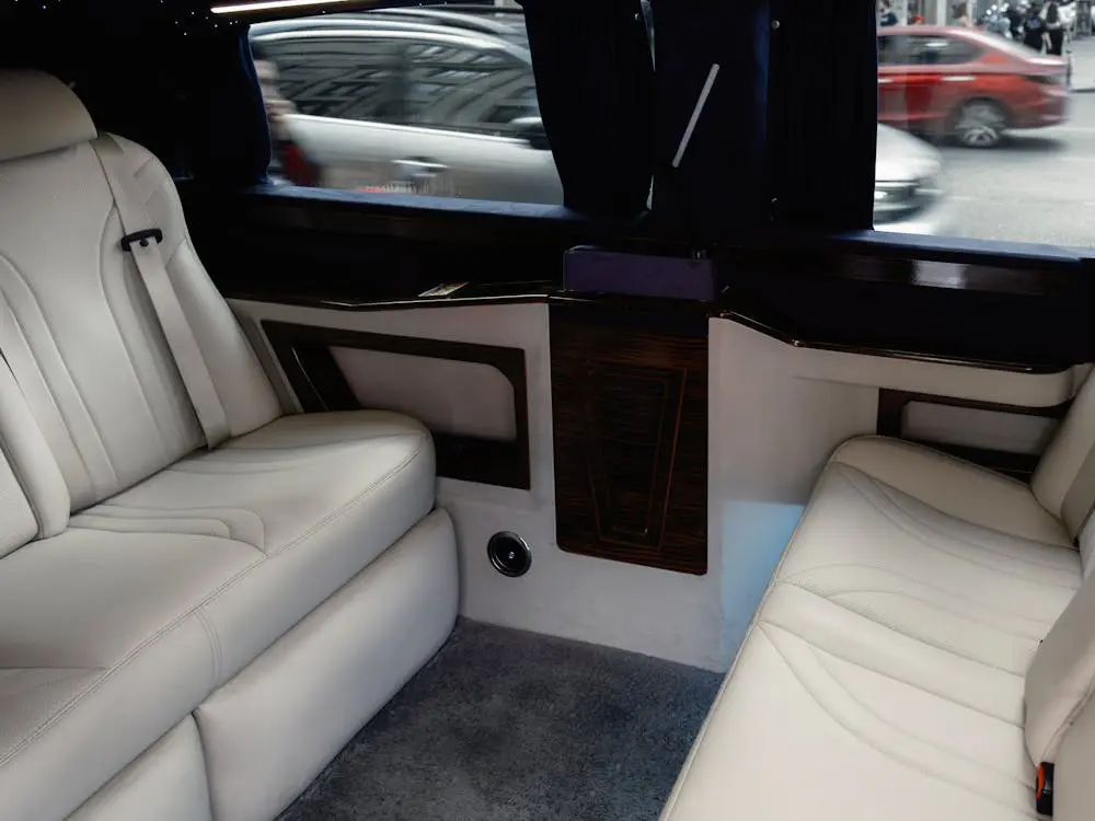 Limousine interior with white leather seats and wood trim